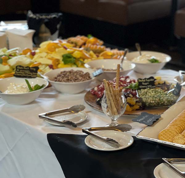 Spread of catered food served by The Androy by Boomtown wedding and event venue catering.