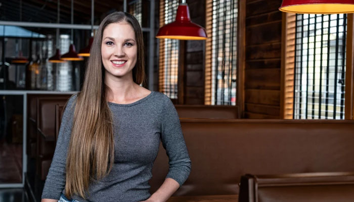 Woman smiling inside a restaurant