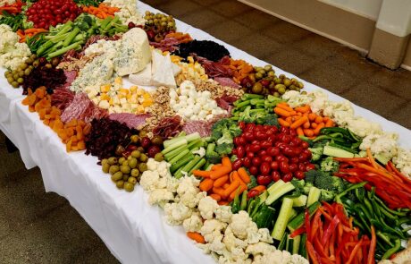 Charcuterie Table set up for an event with cheese and veggies